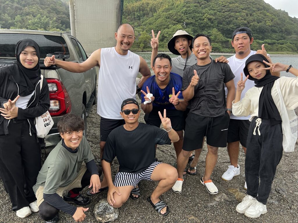 A photo of eight smiling staff members making V signs